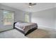 Neutral bedroom with large windows and a ceiling fan, creating a serene and bright atmosphere at 5669 Sands Rd, Hollywood, SC 29449