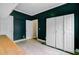 Versatile bonus room with storage cabinets, neutral tile flooring, and bright windows providing natural light at 5669 Sands Rd, Hollywood, SC 29449