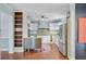 Spacious kitchen featuring stainless steel appliances, white cabinetry, and a movable stainless island at 5669 Sands Rd, Hollywood, SC 29449