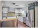 Bright kitchen with stainless steel appliances, white cabinets and decorative backsplash tiles above the countertops at 5669 Sands Rd, Hollywood, SC 29449
