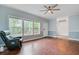Spacious living room with wood-look flooring, a ceiling fan, and access to the dining area at 5669 Sands Rd, Hollywood, SC 29449