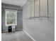 Spacious walk-in closet with gray carpet and walls, bright window, and wire shelving, perfect for organization at 5669 Sands Rd, Hollywood, SC 29449