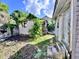 Backyard featuring damaged wood siding and overgrowth at 6 Moultrie St, Charleston, SC 29403