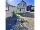 Backyard featuring damaged wood siding and overgrowth at 6 Moultrie St, Charleston, SC 29403