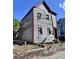 Two-story residence shows weathered wood siding and a modest yard needing repairs at 6 Moultrie St, Charleston, SC 29403