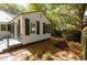 Charming backyard with brick pathway leading to a cozy home with mature trees at 622 Venning St, McClellanville, SC 29458