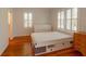 Bedroom featuring hardwood floors, a bed with storage drawers, and natural lighting at 622 Venning St, McClellanville, SC 29458