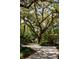 Inviting circular driveway surrounded by mature trees and lush landscaping at 622 Venning St, McClellanville, SC 29458