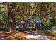 Charming cottage home with a screened-in porch nestled under mature trees at 622 Venning St, McClellanville, SC 29458