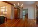 Kitchen featuring wooden floors, white cabinetry, decorative lighting and stainless appliances at 622 Venning St, McClellanville, SC 29458