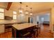Open kitchen with an island, stainless steel appliances, and stylish pendant lighting at 622 Venning St, McClellanville, SC 29458