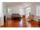 Bright living room featuring hardwood floors, built-in shelving, and natural light at 622 Venning St, McClellanville, SC 29458