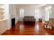 Bright living room featuring hardwood floors, built-in shelving, and natural light at 622 Venning St, McClellanville, SC 29458