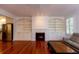 Inviting living room with fireplace, built-in shelving, and hardwood floors at 622 Venning St, McClellanville, SC 29458