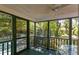 Relaxing screened porch with views of the backyard and mature trees at 622 Venning St, McClellanville, SC 29458