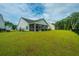 Well-maintained backyard with lush green grass, a screened-in porch, and mature trees at 7070 Pumpkinseed Dr, Johns Island, SC 29455