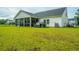 Expansive backyard with lush green lawn and a covered patio perfect for outdoor entertaining at 7070 Pumpkinseed Dr, Johns Island, SC 29455