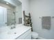 Bright bathroom featuring a white vanity, toilet, decorative ladder, and shower with curtain at 7070 Pumpkinseed Dr, Johns Island, SC 29455