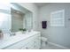 Well-lit bathroom with double sinks, white cabinets, a large mirror, and a separate shower and toilet at 7070 Pumpkinseed Dr, Johns Island, SC 29455