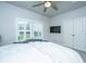 Bright bedroom featuring a ceiling fan, window with shutters, and a flat screen TV on the wall at 7070 Pumpkinseed Dr, Johns Island, SC 29455
