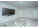 Inviting bonus room with neutral carpet and paint, large TV, and access to additional spaces at 7070 Pumpkinseed Dr, Johns Island, SC 29455