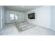 Spacious bonus room with plush carpeting, large windows and a wall-mounted television at 7070 Pumpkinseed Dr, Johns Island, SC 29455