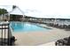 Community pool and clubhouse with seating, perfect for relaxing and socializing by the water at 7070 Pumpkinseed Dr, Johns Island, SC 29455