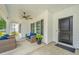 Cozy, covered porch featuring comfortable wicker seating and a stylish ceiling fan at 7070 Pumpkinseed Dr, Johns Island, SC 29455