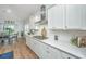 Modern kitchen with white cabinets, stainless steel appliances, a gas cooktop, and an adjacent dining area at 7070 Pumpkinseed Dr, Johns Island, SC 29455