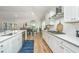 Modern kitchen with white cabinets, stainless steel appliances, a gas cooktop, and an adjacent dining area at 7070 Pumpkinseed Dr, Johns Island, SC 29455