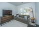Cozy living room with a gray sofa, accent pillows, a wooden dresser, a TV, and a floor lamp at 7070 Pumpkinseed Dr, Johns Island, SC 29455