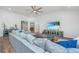 Bright living room featuring vaulted ceilings, a ceiling fan and a comfortable gray sectional sofa at 7070 Pumpkinseed Dr, Johns Island, SC 29455