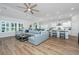 Open concept living room and kitchen with modern furniture and hardwood floors at 7070 Pumpkinseed Dr, Johns Island, SC 29455