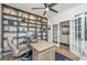 Office with built in bookshelves, modern desk, and french doors at 7070 Pumpkinseed Dr, Johns Island, SC 29455