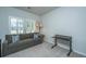 Comfortable office space with a gray couch, side table, floor lamp, and a rolling desk at 7070 Pumpkinseed Dr, Johns Island, SC 29455