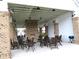 Outdoor seating area with a fireplace, offering a covered space for gatherings and relaxation at 7070 Pumpkinseed Dr, Johns Island, SC 29455