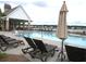 Inviting community pool with lounge chairs and a covered pavilion, perfect for relaxing and enjoying the outdoors at 7070 Pumpkinseed Dr, Johns Island, SC 29455