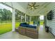 Cozy screened-in porch featuring comfortable seating, ceiling fan, and ambient string lights at 7070 Pumpkinseed Dr, Johns Island, SC 29455