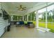 Charming screened porch with outdoor furniture, a ceiling fan, and a view of the manicured lawn at 7070 Pumpkinseed Dr, Johns Island, SC 29455