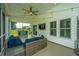 Relaxing screened porch with stylish furniture, a ceiling fan, and views of the backyard at 7070 Pumpkinseed Dr, Johns Island, SC 29455