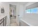 Bathroom featuring a soaking tub next to a vanity, with a doorway leading to the bedroom at 7401 Purser Ln, Hanahan, SC 29410