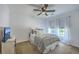 Cozy bedroom with stylish bedding, a ceiling fan, and bright windows with curtains at 7401 Purser Ln, Hanahan, SC 29410