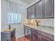 Butlers pantry with dark wood cabinets, granite counters, beverage cooler, and under cabinet lighting at 7401 Purser Ln, Hanahan, SC 29410
