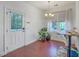 Bright dining area featuring natural light, a stylish light fixture, and wood flooring at 7401 Purser Ln, Hanahan, SC 29410
