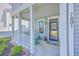 Inviting covered front porch with rocking chairs and decorative plants at a beautiful two-story home at 7401 Purser Ln, Hanahan, SC 29410