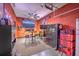 Finished garage with ceiling fan, wall-mounted TV, high-top table with barstools, safe, tool storage and neon beer signs at 7401 Purser Ln, Hanahan, SC 29410