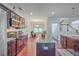Open-concept kitchen features granite countertops, stainless appliances and island seating flowing into living spaces at 7401 Purser Ln, Hanahan, SC 29410