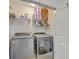 Well-organized laundry room with modern washer and dryer, plus shelving for storage at 7401 Purser Ln, Hanahan, SC 29410