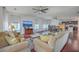 Open-concept living room featuring hardwood floors, comfortable seating, and kitchen access at 7401 Purser Ln, Hanahan, SC 29410