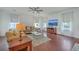 Bright living room featuring hardwood floors, comfortable seating, and large windows with natural light at 7401 Purser Ln, Hanahan, SC 29410